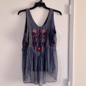 Beautiful tank top with lace and embroidery detail, sheer fabric on bottom half.